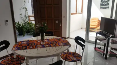 a room with a table and chairs and a television at ka-Bela in Sal Rei