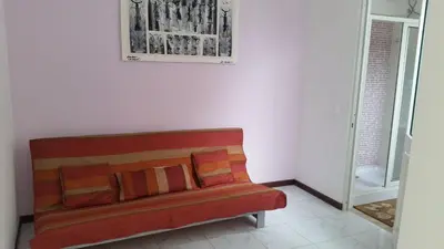 a couch in a room with a picture on the wall at ka-Bela in Sal Rei
