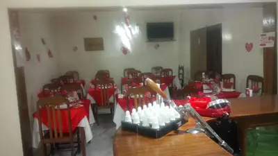 a conference room with a table and chairs with red table cloth at Residencial Vitoria in Ponta do Sol