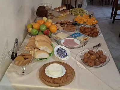 a table with many different types of food on it at Residencial Vitoria in Ponta do Sol