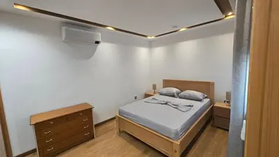 a small bedroom with a bed and a dresser at Apto Duarte T2 in Praia