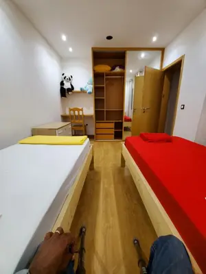 a person is constructing a bed in a room at Apto Duarte T2 in Praia