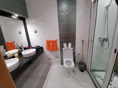 a bathroom with two sinks and a toilet and a shower at Apto Duarte T2 in Praia