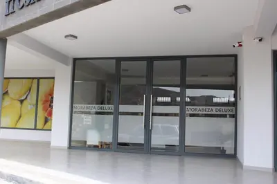 a building with glass doors on the side of it at Kasa Imbondeiro in Mindelo