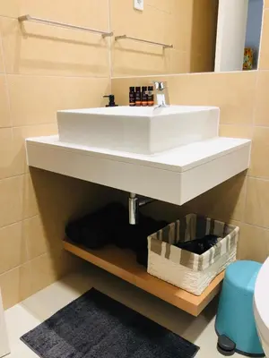 a bathroom with a white sink and a mirror at Kasa Imbondeiro in Mindelo