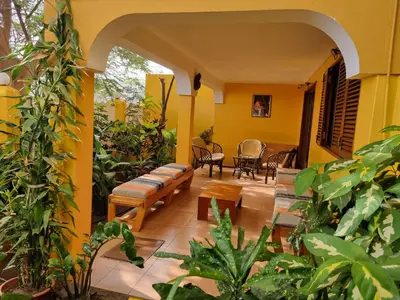 a patio with chairs and plants in a house at O Jardim do Vinho, AC in Praia