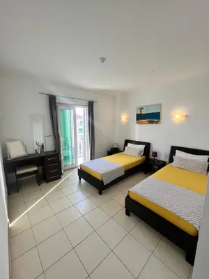 a bedroom with two beds and a desk in it at Apartment in Vila Verde - Pool view - Santa Maria in Santa Maria