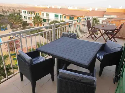 a table and chairs on a balcony with a view of the beach at Apartment in Vila Verde - Pool view - Santa Maria in Santa Maria