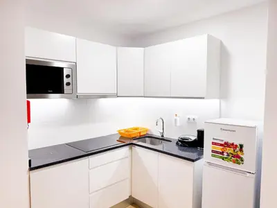 a white kitchen with a sink and a refrigerator at BIA D'Olaf Apartments in Santa Maria