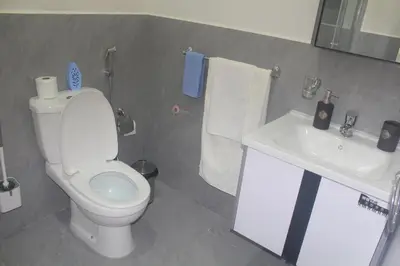 a bathroom with a white toilet and a sink at Residence A Paz in Boa Ventura