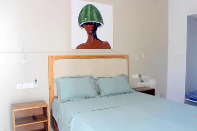 a bedroom with a bed with a water melon on the headboard at Residence A Paz in Boa Ventura