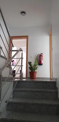 a stairway with a potted plant on the wall at Apartamentos DECOR in Tarrafal