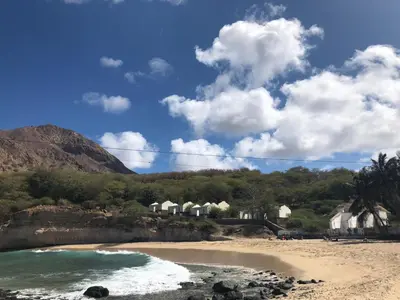 a beach with a group of houses in the background at Apartamentos DECOR in Tarrafal