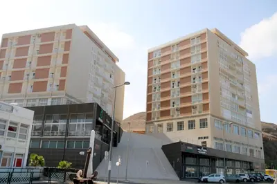 two tall buildings with cars parked in front of them at Complexo Multiuso Copacabana in Mindelo