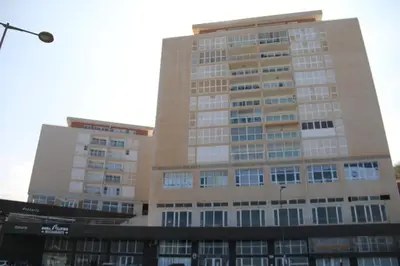 a tall building with a lot of windows at Complexo Multiuso Copacabana in Mindelo