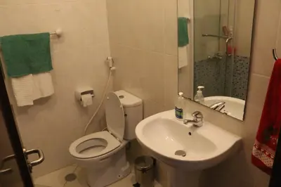a small bathroom with a toilet and a sink at Complexo Multiuso Copacabana in Mindelo