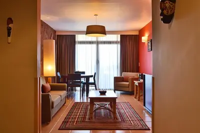 a living room with a couch and a table at Pestana Tropico Ocean & City Hotel in Praia