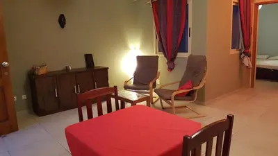 a living room with a red table and chairs at OKEANOS in Sal Rei