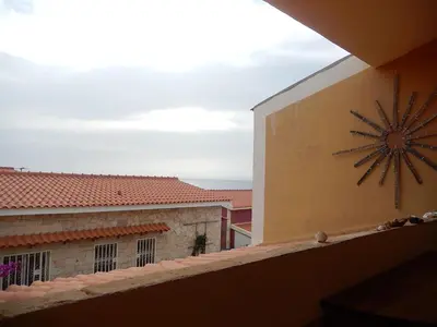 a large clock on the side of a building at Residenz Stella Maris Apartment Strela in Vila do Maio