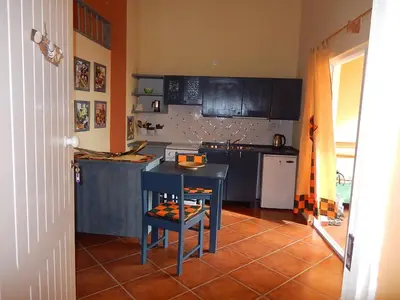a kitchen with a blue table in a kitchen at Residenz Stella Maris Apartment Strela in Vila do Maio