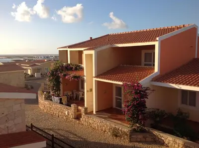 a view of a house with flowers on the balconies at Residenz Stella Maris Apartment Strela in Vila do Maio