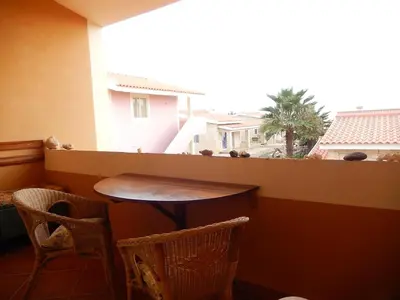 a table and chairs in a room with a window at Residenz Stella Maris Apartment Strela in Vila do Maio