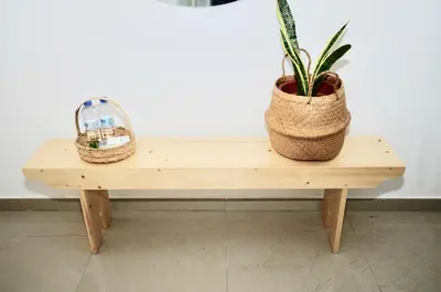 a wooden bench with a potted plant on it at Casa Sodadi in Praia