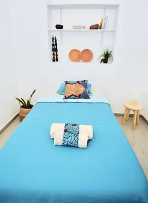 a bedroom with a blue bed with towels on it at Casa Sodadi in Praia