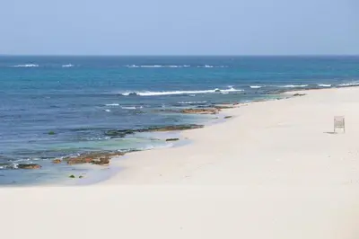 a beach with a chair and the ocean at Special Price long term in Sal Rei