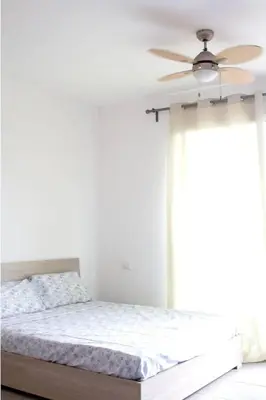 a bedroom with a bed and a ceiling fan at Special Price long term in Sal Rei
