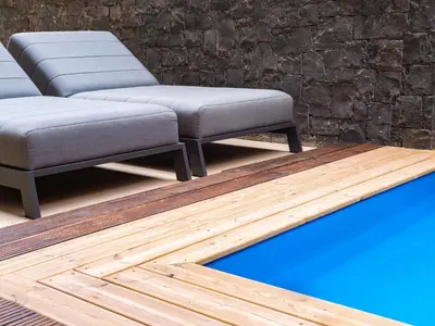 a row of benches in front of a brick wall at Angulo House in Santa Maria