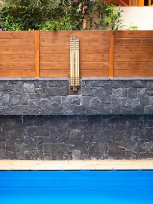 a retaining wall with a wooden fence at Angulo House in Santa Maria