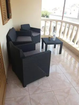 a living room with two chairs and a table at Casa Yô in Mindelo