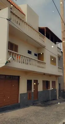 a large white house with a balcony on top of it at Casa Yô in Mindelo