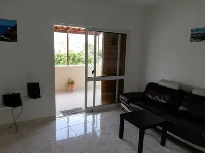a living room with a black leather couch and a table at Casa Yô in Mindelo