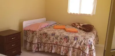 a small bedroom with a bed with two towels on it at Casa helena in Portela