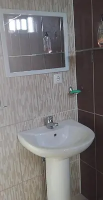 a bathroom with a white sink and a mirror at Casa helena in Portela