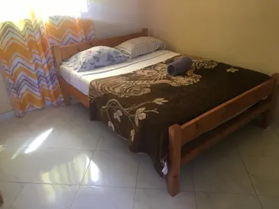 a small bed in a room with a brown blanket at Casa helena in Portela