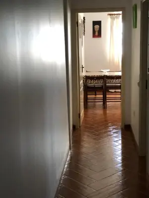 a hallway with a room with a table and a door at Charming 2BR with Refreshing Ocean View in Praia