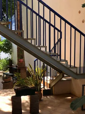 a metal staircase with a potted plant next to it at Charming 2BR with Refreshing Ocean View in Praia
