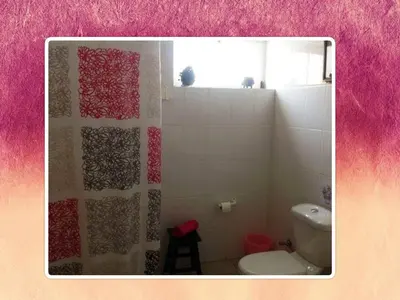 a bathroom with a toilet and a shower curtain at Charming 2BR with Refreshing Ocean View in Praia