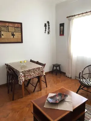 a living room with a table and chairs and a table at Charming 2BR with Refreshing Ocean View in Praia