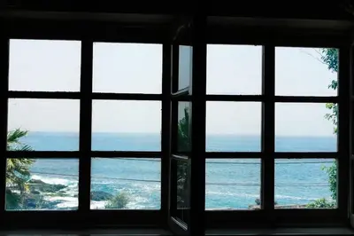 a view of the ocean from a window at Charming 2BR with Refreshing Ocean View in Praia