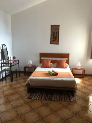 a bedroom with a bed and a tiled floor at XXL Apt w/ Surprising Gorgeous Ocean View in Praia