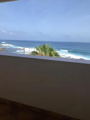 a view of the ocean from a balcony at Couple Getaway with Panoramic Ocean View in Praia