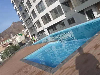 a swimming pool in front of a building at Apartment with pool in Mindelo in Mindelo