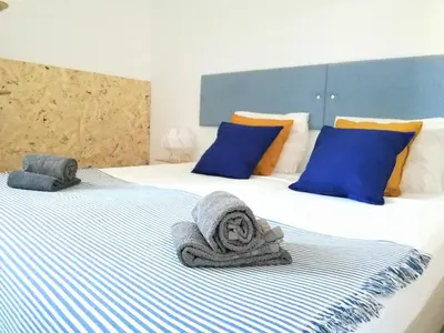 a bedroom with two beds with towels on them at Casa Blu Guesthouse - Casa de Hospedes in Santa Maria