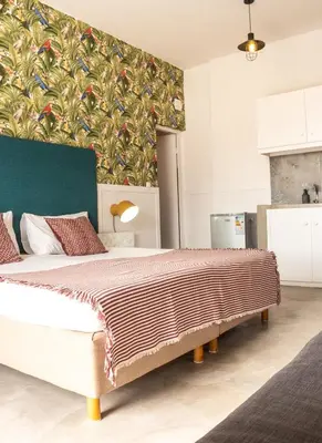 a bedroom with a large bed with a colorful wall at Casa Blu Guesthouse - Casa de Hospedes in Santa Maria