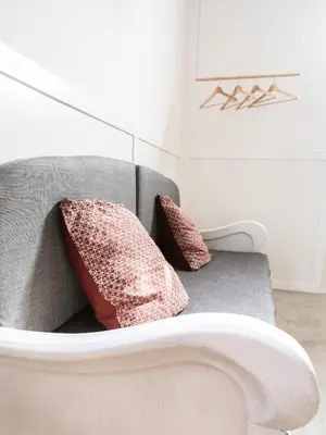 a couch with two pillows on it in a room at Casa Blu Guesthouse - Casa de Hospedes in Santa Maria
