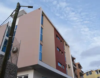 a building with white and red at Domingas in Praia